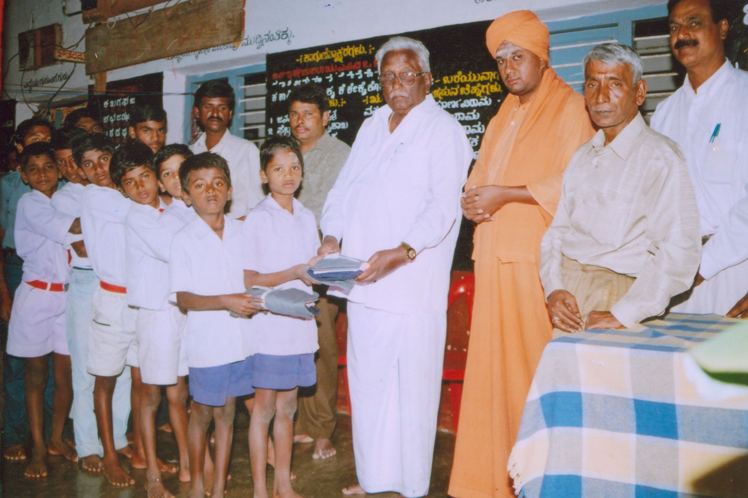 Earlier Guru with students and community members in an institutional gathering