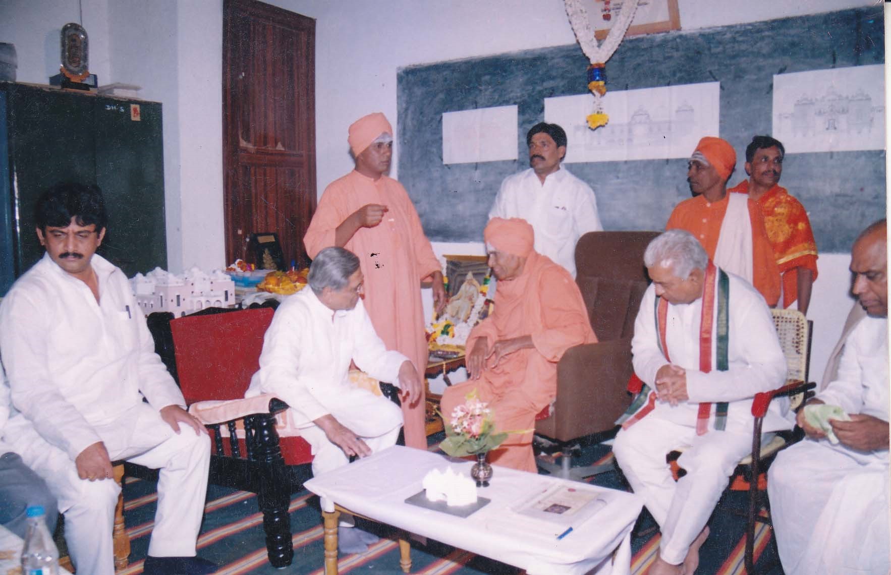 A meeting between public guests and revered Swamijis inside the Mutt